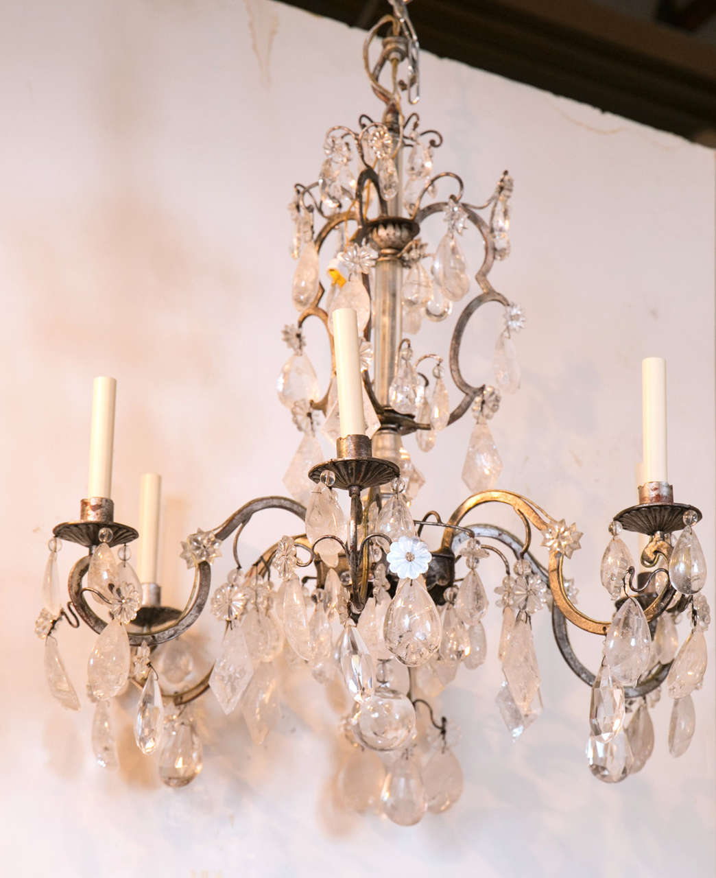A six-light silvered gilt iron and solid, faceted original rock crystal chandelier by Bagues, France.
