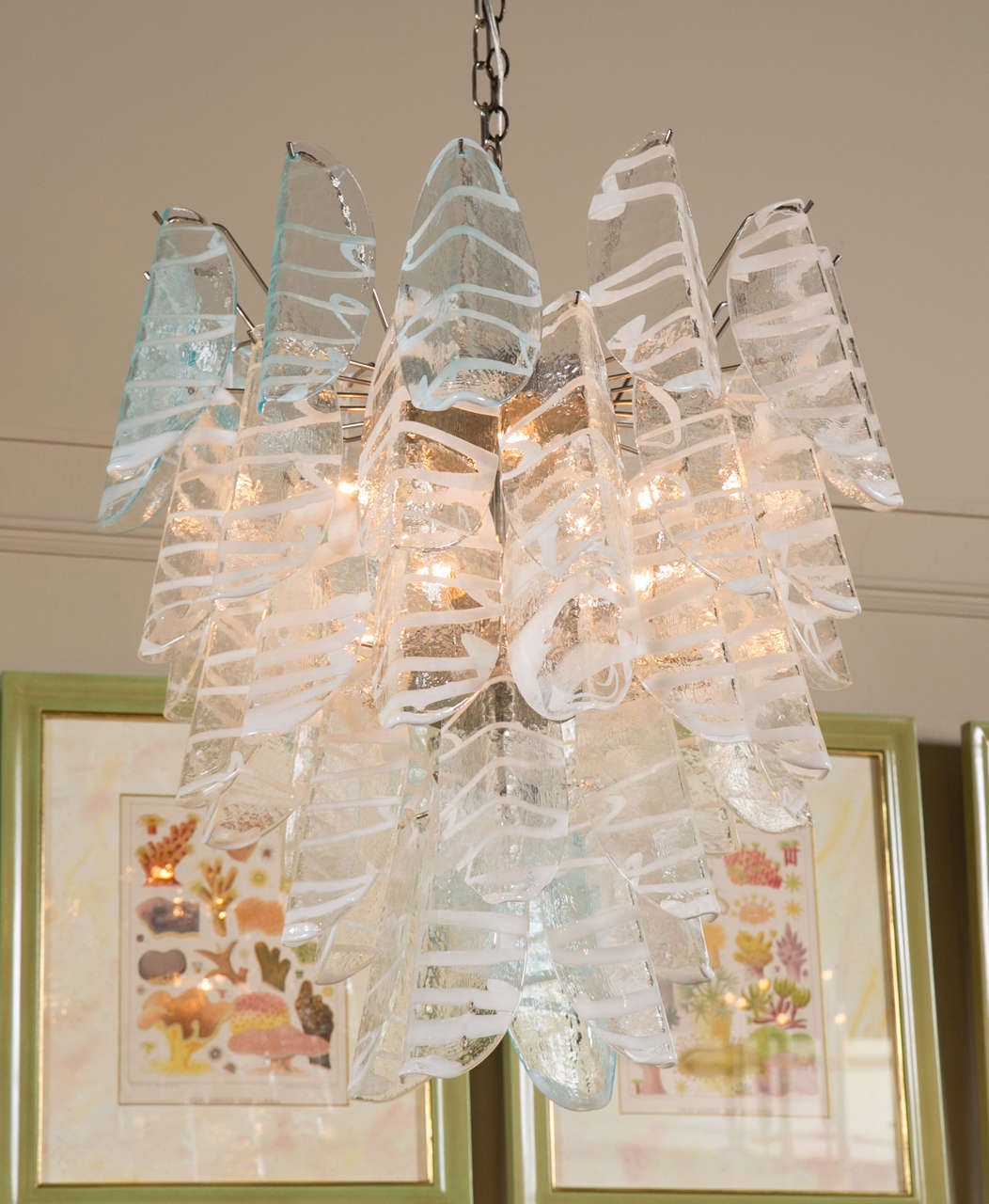 A spectacular Murano glass chandelier with tiered five pendants of clear and light blue prisms.