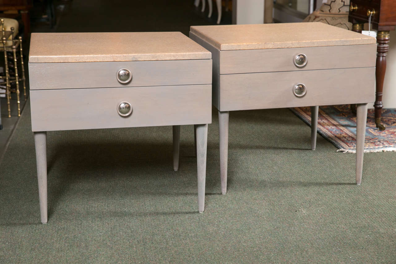 A pair of Paul Frankl for Johnson Furniture Co. end or bedside tables having cork tops over two drawers. Manufacturer's stamp inside of drawer.