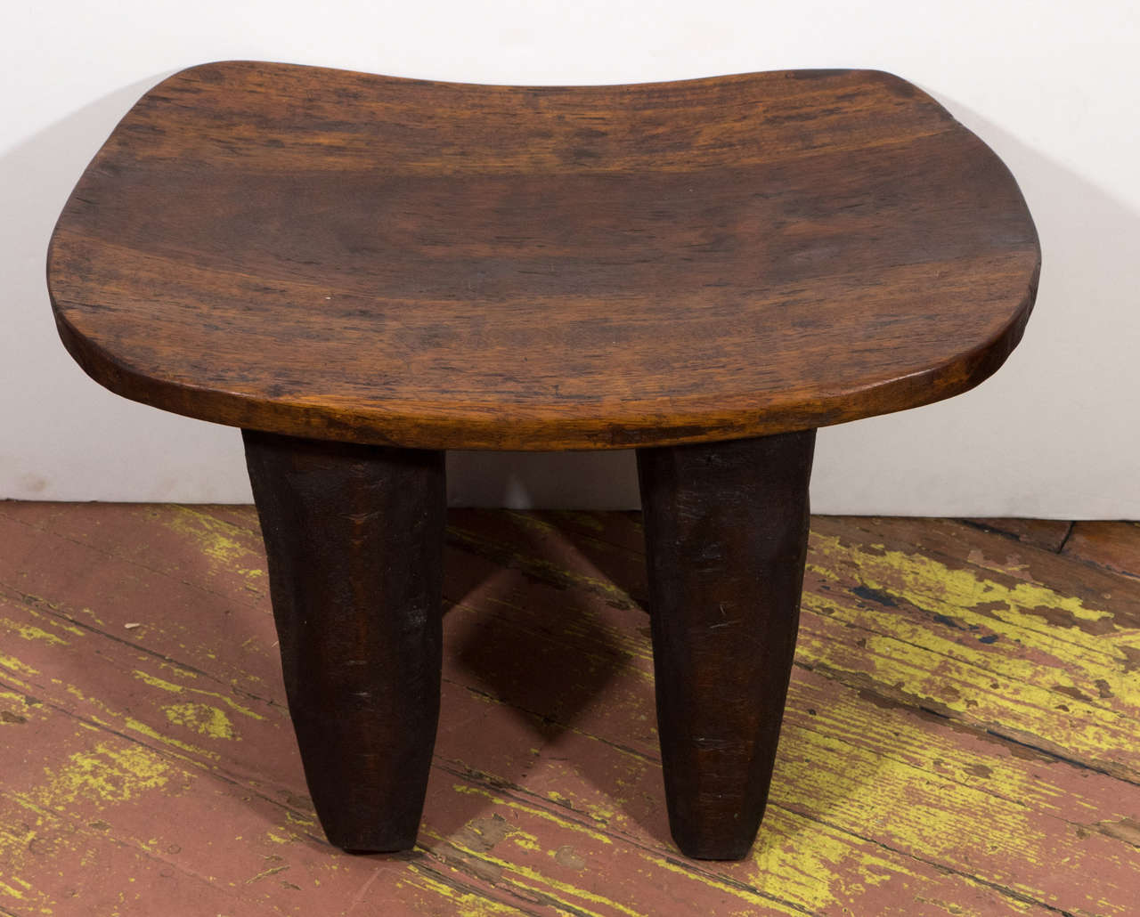 Hand-carved stool made from one solid piece of wood.