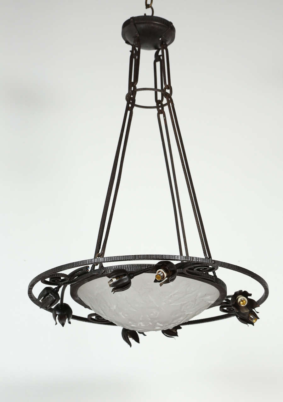 Graceful French iron and glass fixture. Glass is signed Muller Freres. Newly rewired for nine candelabra bulbs; each bulb can be up to 60 watts. Two available.