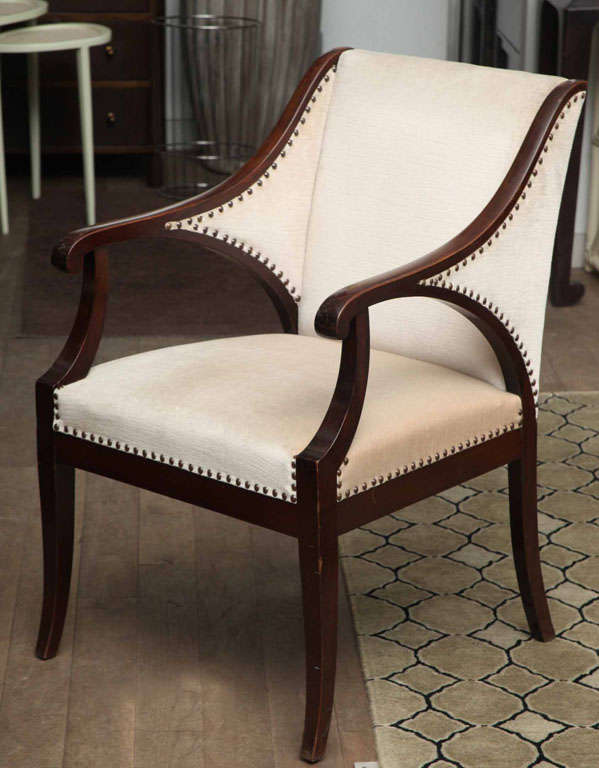 Pair of French Art Deco mahogany armchairs with natural finish nailheads circa 1930