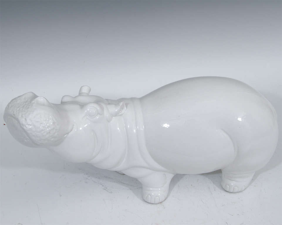 Charming, life like white glazed ceramic figures of a hippopotamus and a musk ox. Hippo is numbered and signed 