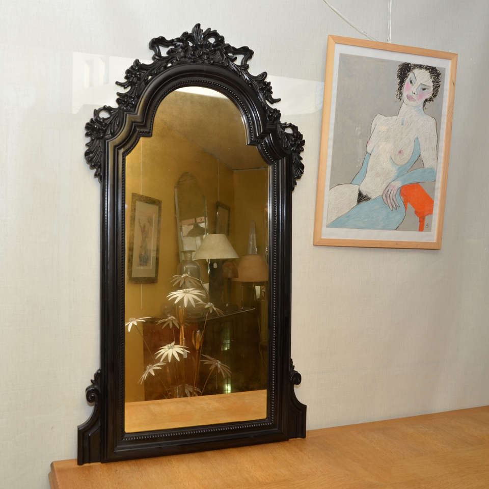Napoleon III Mirror1860-1880 
mirror with frame in darkened solid mahogany decorated with floral motifs.
