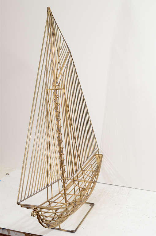 A vintage standing brass sculpture of a sailboat. The piece is signed and dated (1983) on the bow.

Reduced from:  $1,150