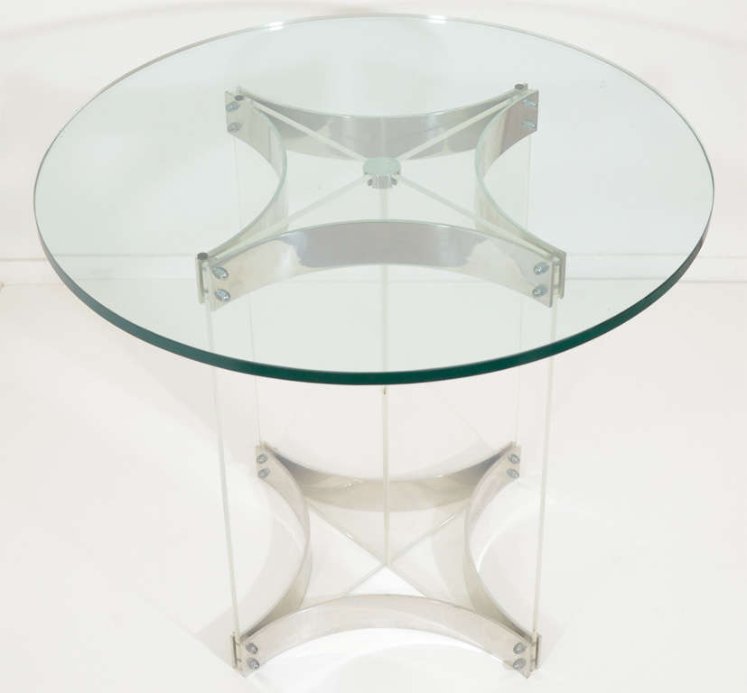 A vintage Charles Hollis Jones side table with a circular glass top and clear lucite base with chrome detailing. The piece is in good vintage condition with age appropriate wear; some scratches to lucite and glass.