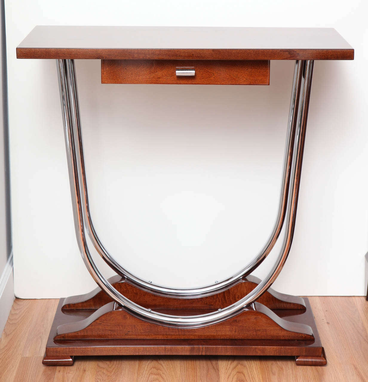 Pair of Machine aged Art Deco console tables with small drawer and double chrome U-support.