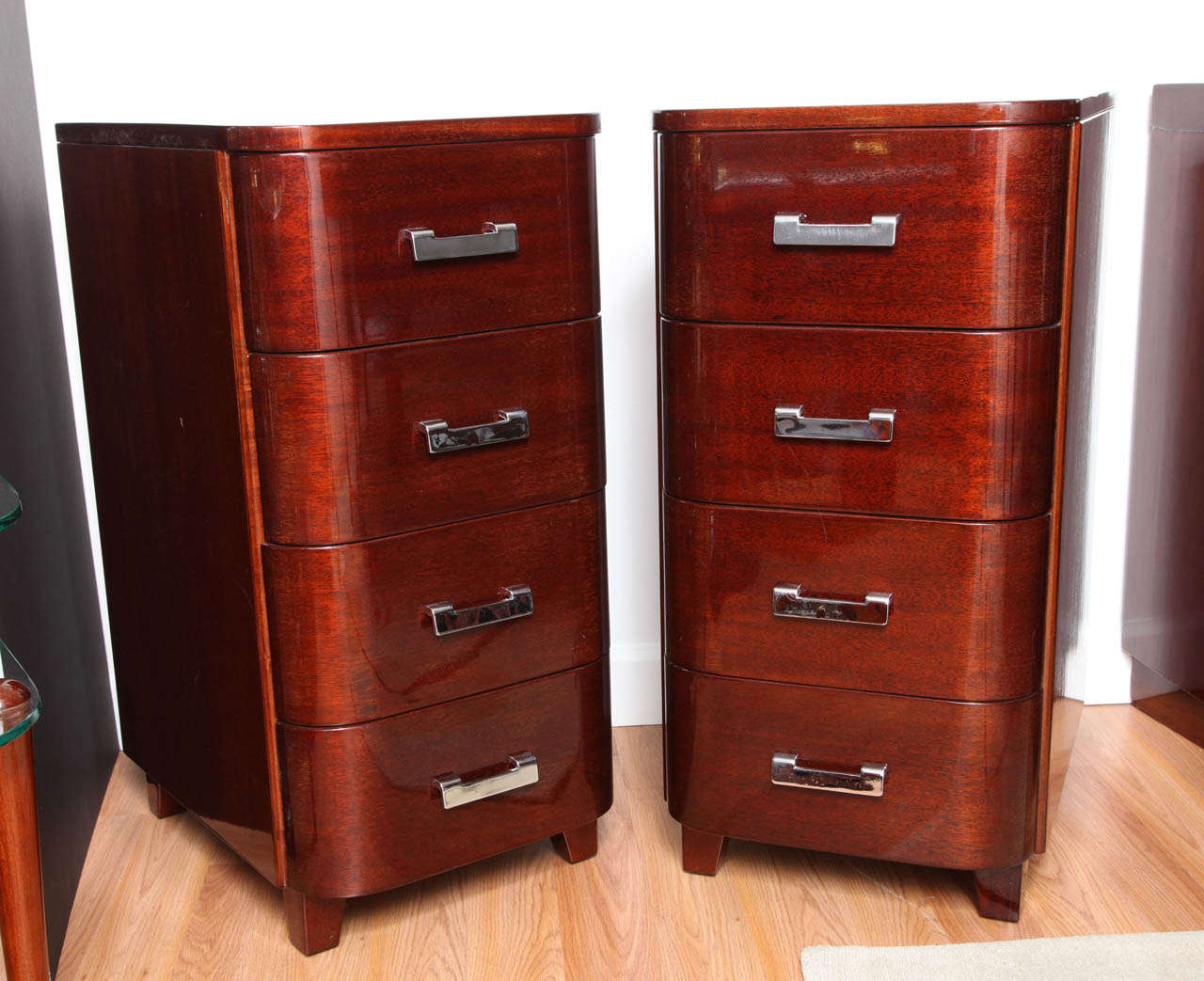 Pair of tall Art Deco streamline nightstands with four drawers in solid mahogany.