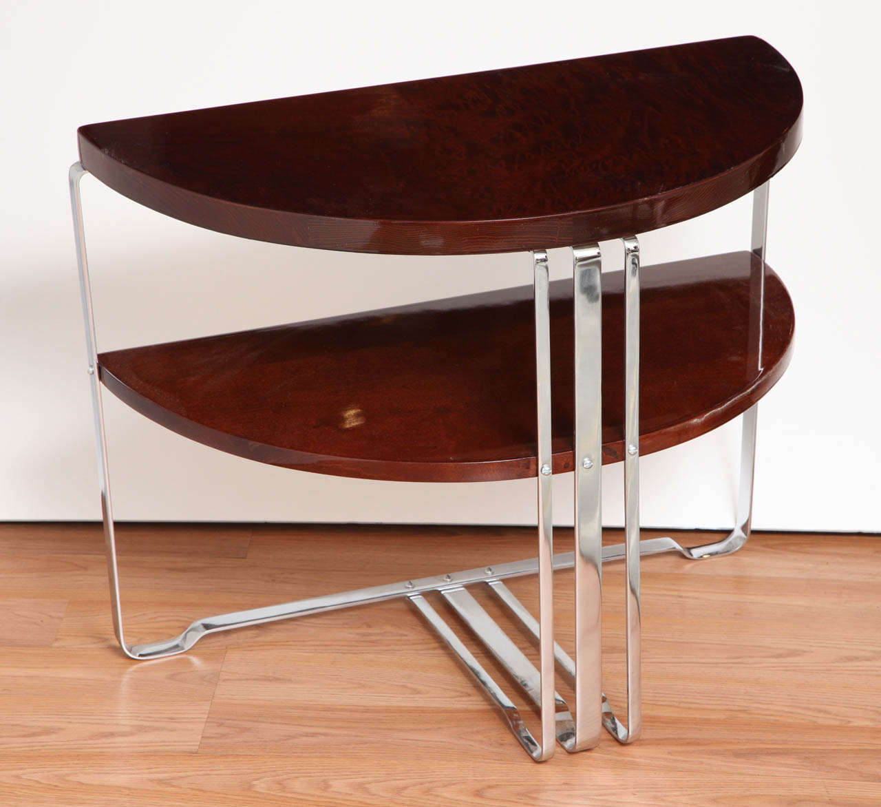 Single machine age Art Deco half circle side table. Possibly by Howell in walnut burl and polished chrome.