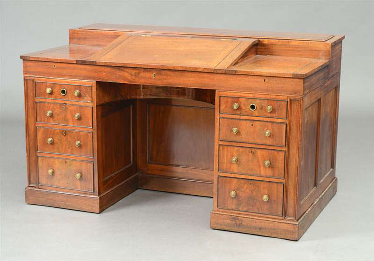 This very fine desk made during the Regency period in England is of great design and exceptional quality. Constructed of Mahogany solids and veneers with fine figure and color. The desk can be used in a number of ways through the operation of cranks