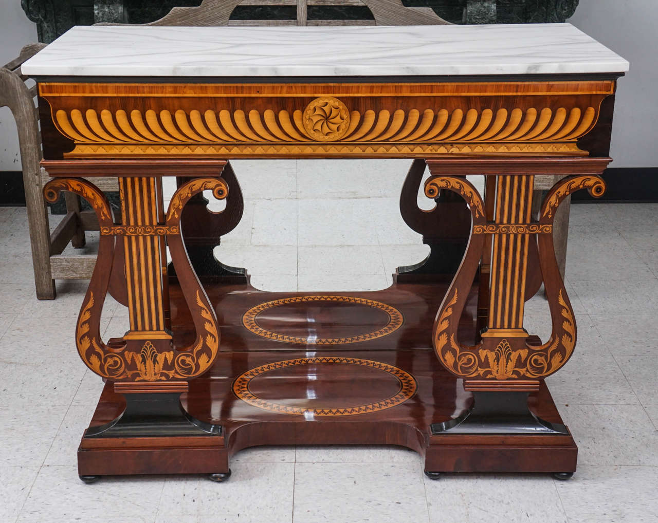 This finely crafted console is Austrian, circa 1830-1840. Designed as a flat mahogany surface richly inlaid in holly, fruitwood, and ebony the piece is further worked by careful sand burning creating a full trompe l'oeil articulated shading. The