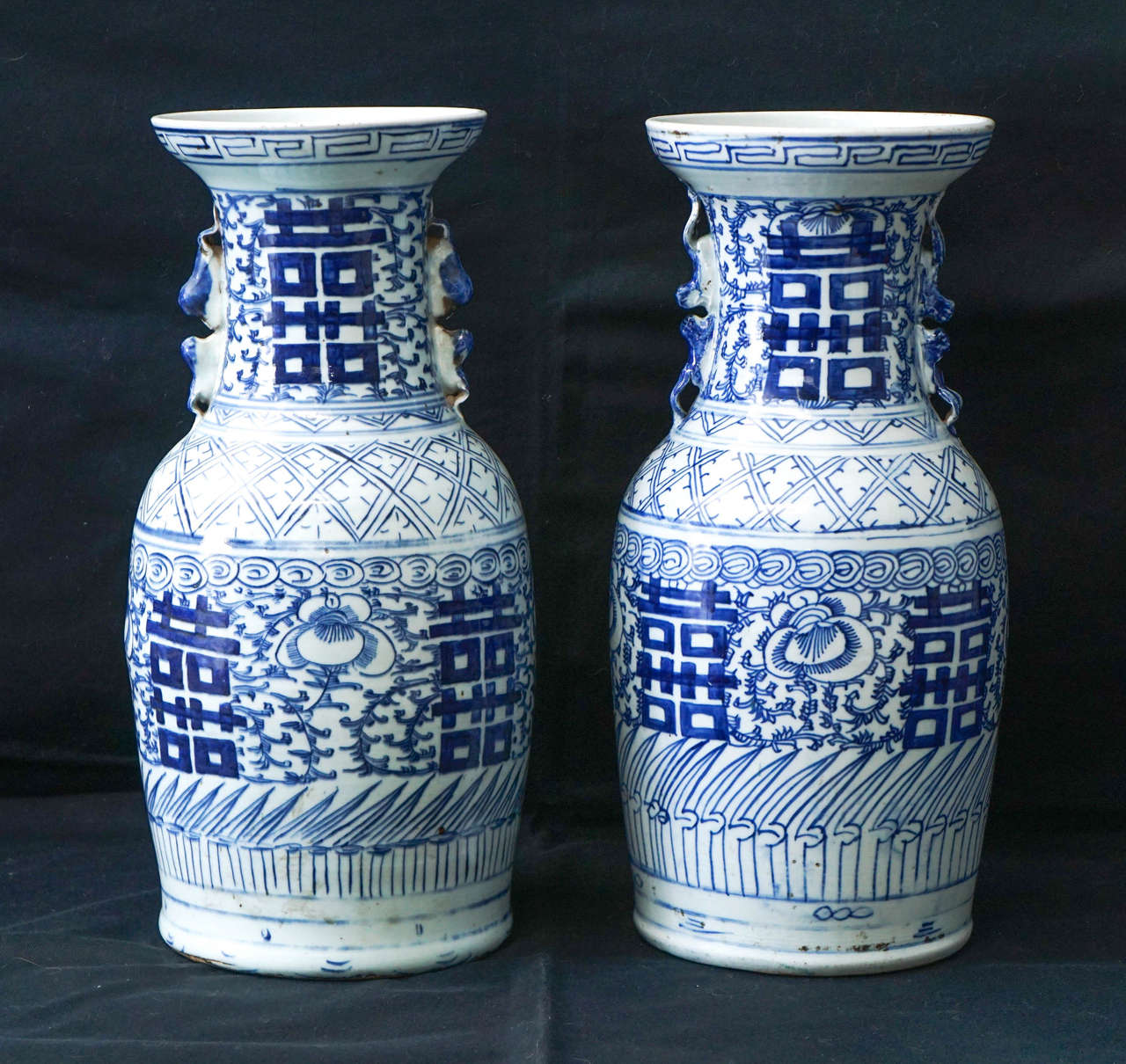 This pair of blue and white Chinese porcelain vases were made for export to the west. Created as an economic commodity they represented standard Chinese themes but formatted and shipped to the west creating an instant exotic element in Victorian
