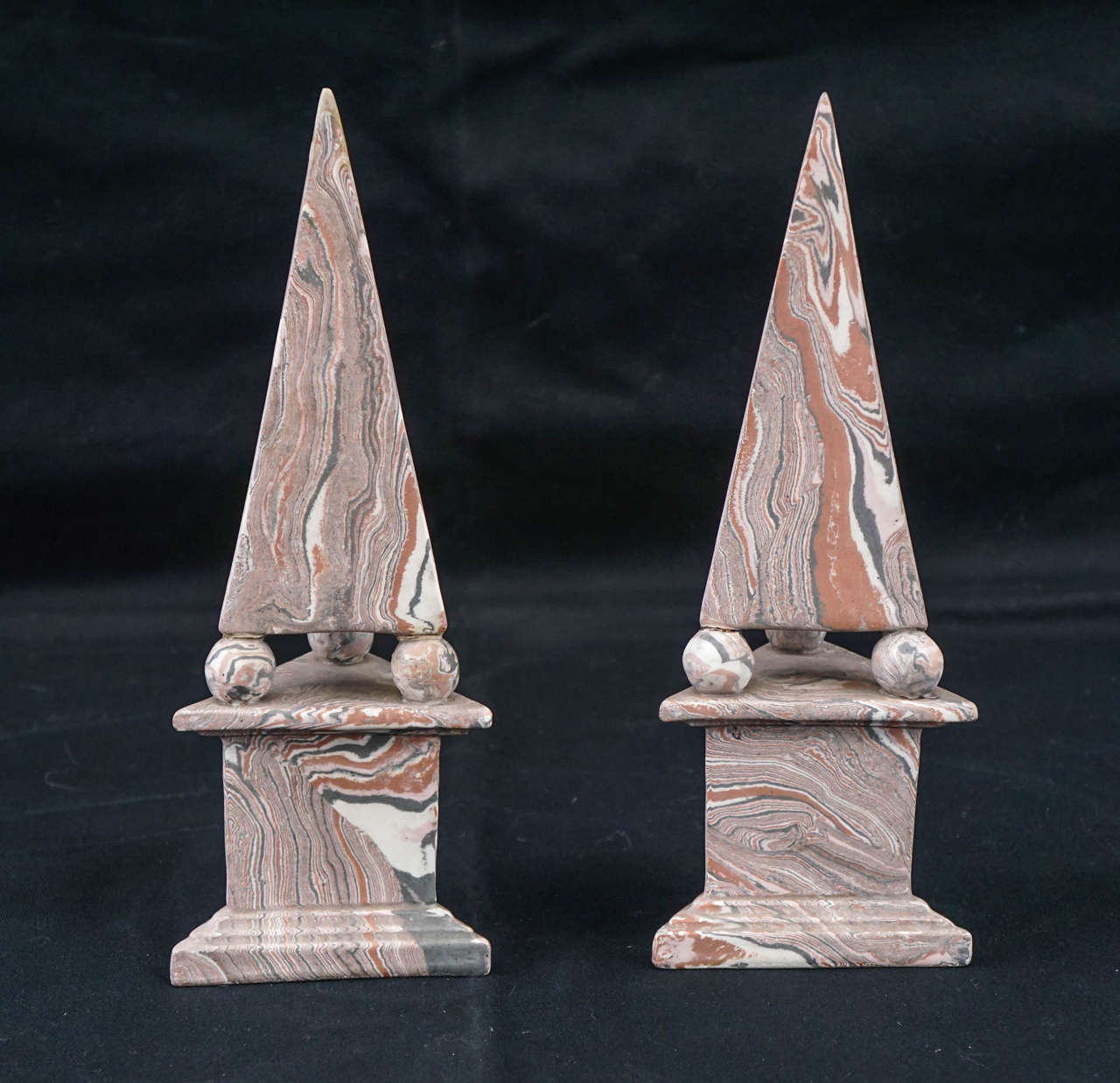 This pair of objects were made around 1900 to 1910 in Italy. They are crafted from hand-molded terra cotta that has been marbleized with colored slip and fired in low heat creating a matte surface. The unusual triangular form is based on 16th  &