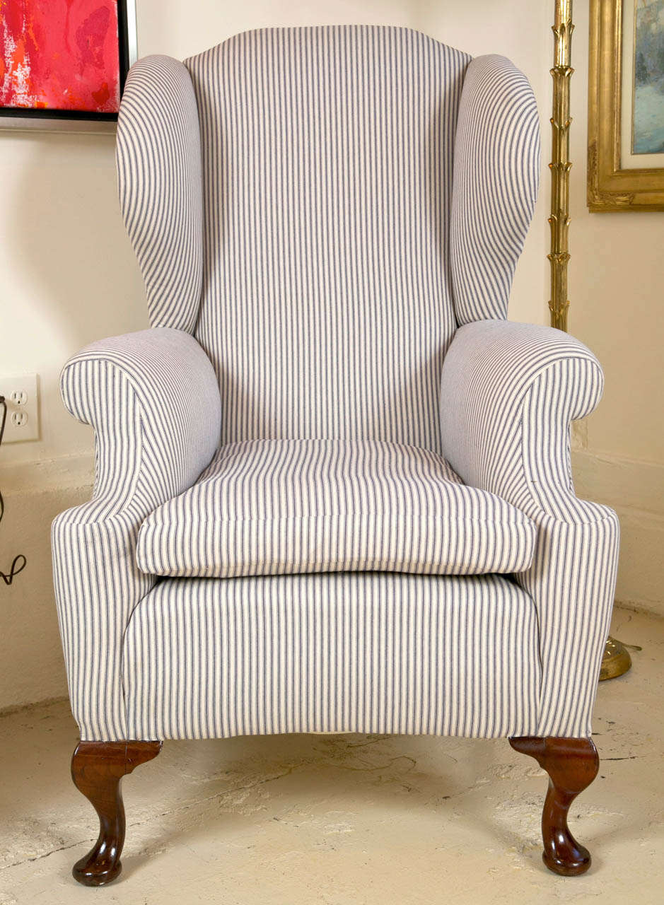 Fabulous English wing back chair. Newly upholstered in cotton ticking fabric,
great proportions. rear legs have original brass casters.