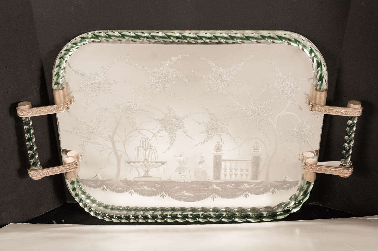 This mirrored and etched glass tray from the island of Murano in the Venetian  republic
( now Italy) is a fine example of the glasswork done in this region for centuries. The bottom centers on an etched mirror plate showing a court couple dressed in
