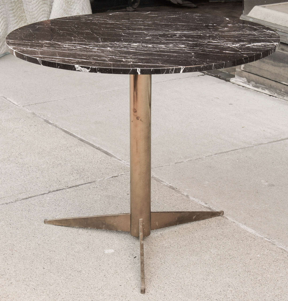 This lovely simple gueridon or small table is from the 70's and was part of a  decorative scheme done circa 1975 for a single owner home in that decade. The table is made from cast brass with iron inner supports for strength. The top is of Coda