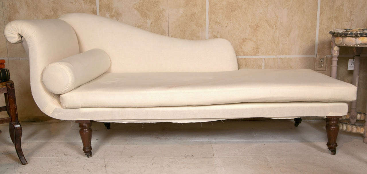 Sleek 19th c English chaise freshly covered in muslin. Casters on feet.