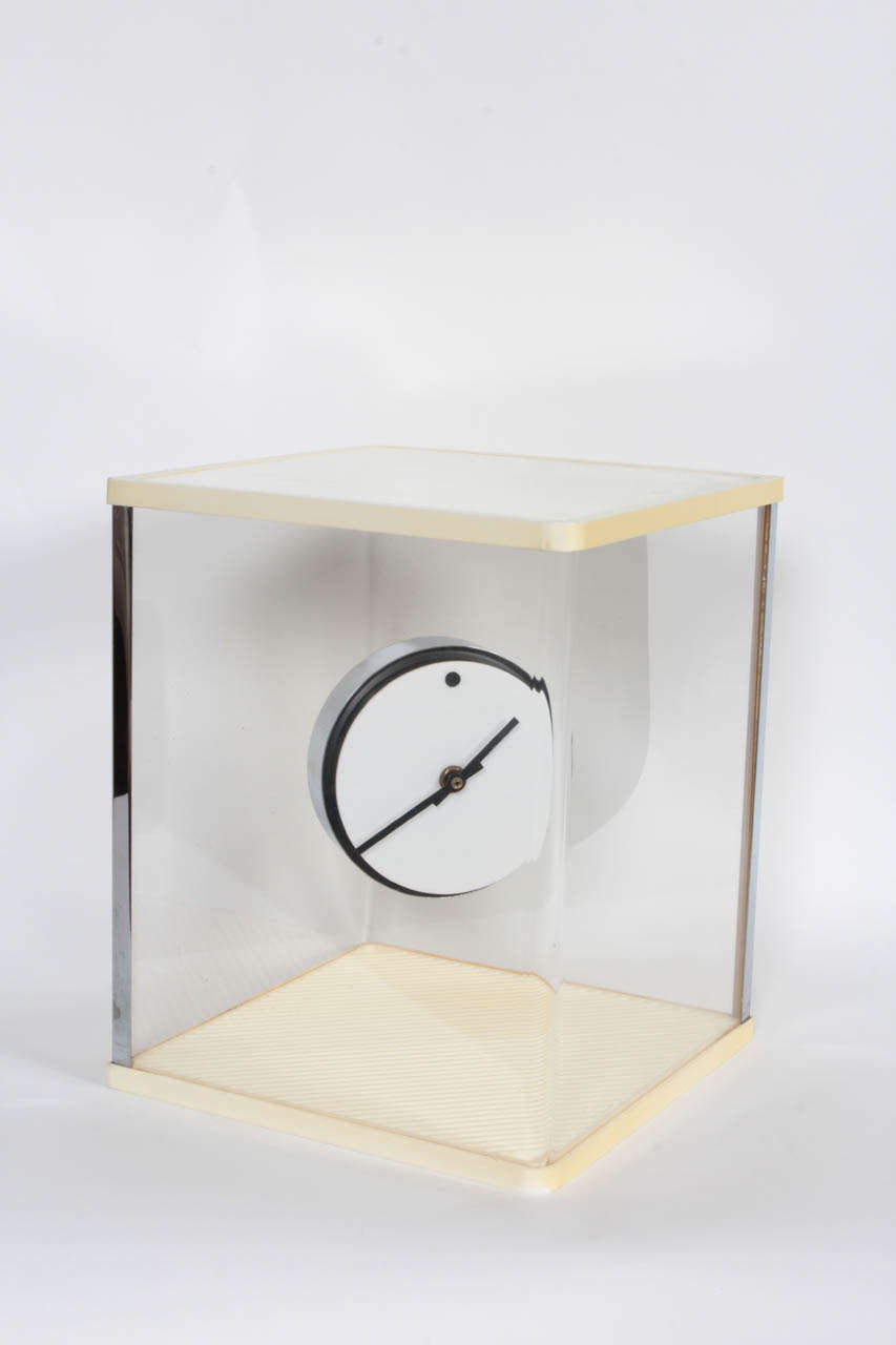 A white lucite and chrome disk clock 