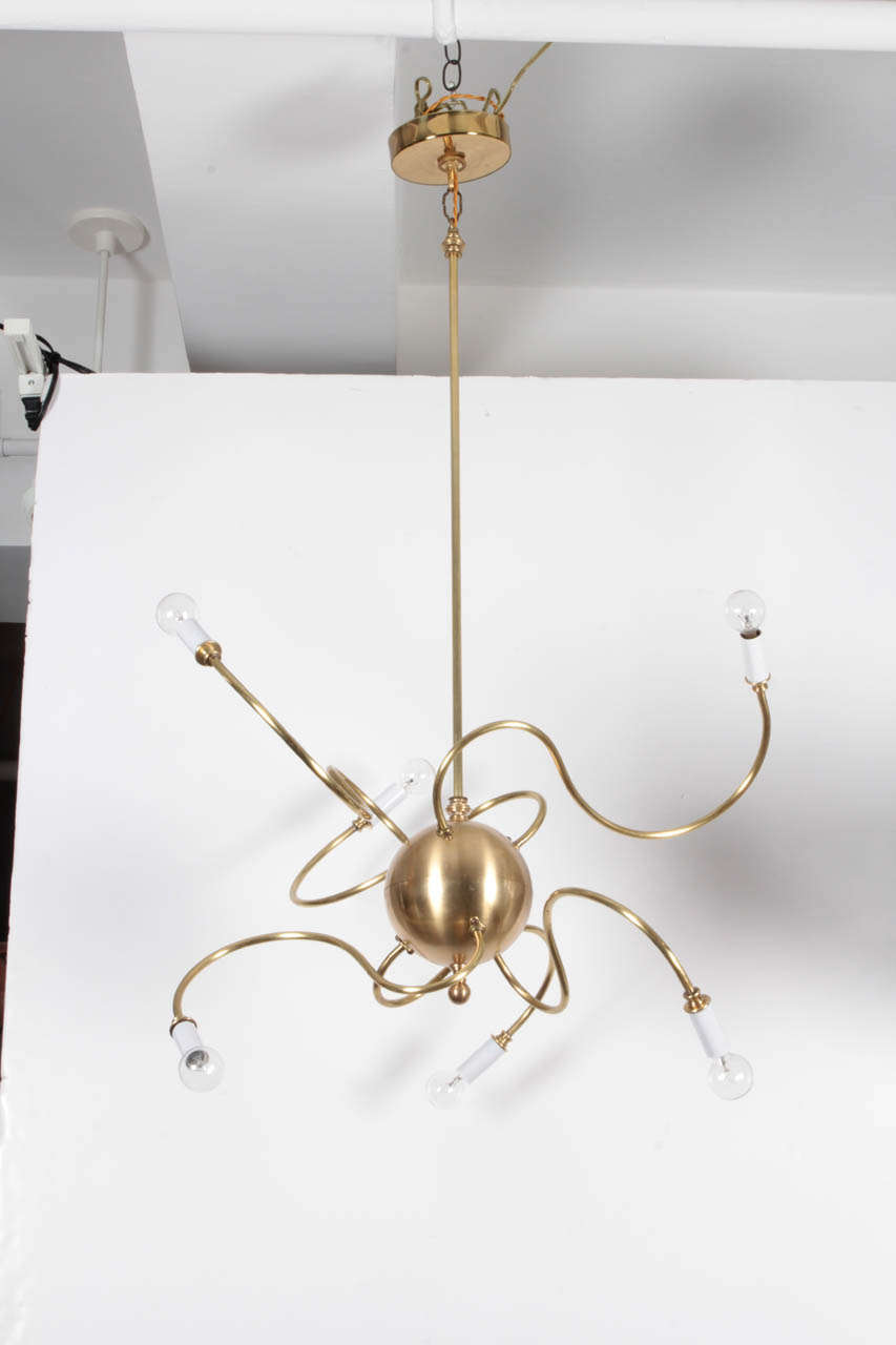 Atom-inspired brass sputnik-style light fixture with six arms.  USA, circa 1980.  Includes canopy.  Wired for U.S.; takes six candelabra-base bulbs; 40 watts each.

Dimensions:
24 inch diameter
36 inch total height including hanging stem
18