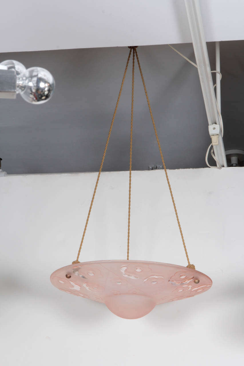 Lalique-style, floral-motif, pink colored-glass pendant light fixture with silk braided hanging cord.  Made by Deguez.  Signed.  France, circa 1940.