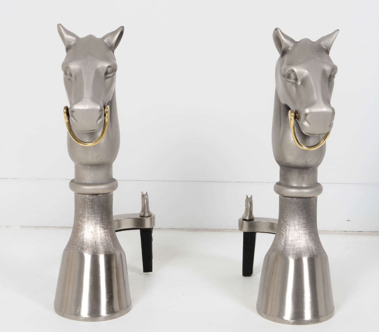 Fantastic pair of Hermes style satin nickel stylized horse andirons with a polished brass bit.