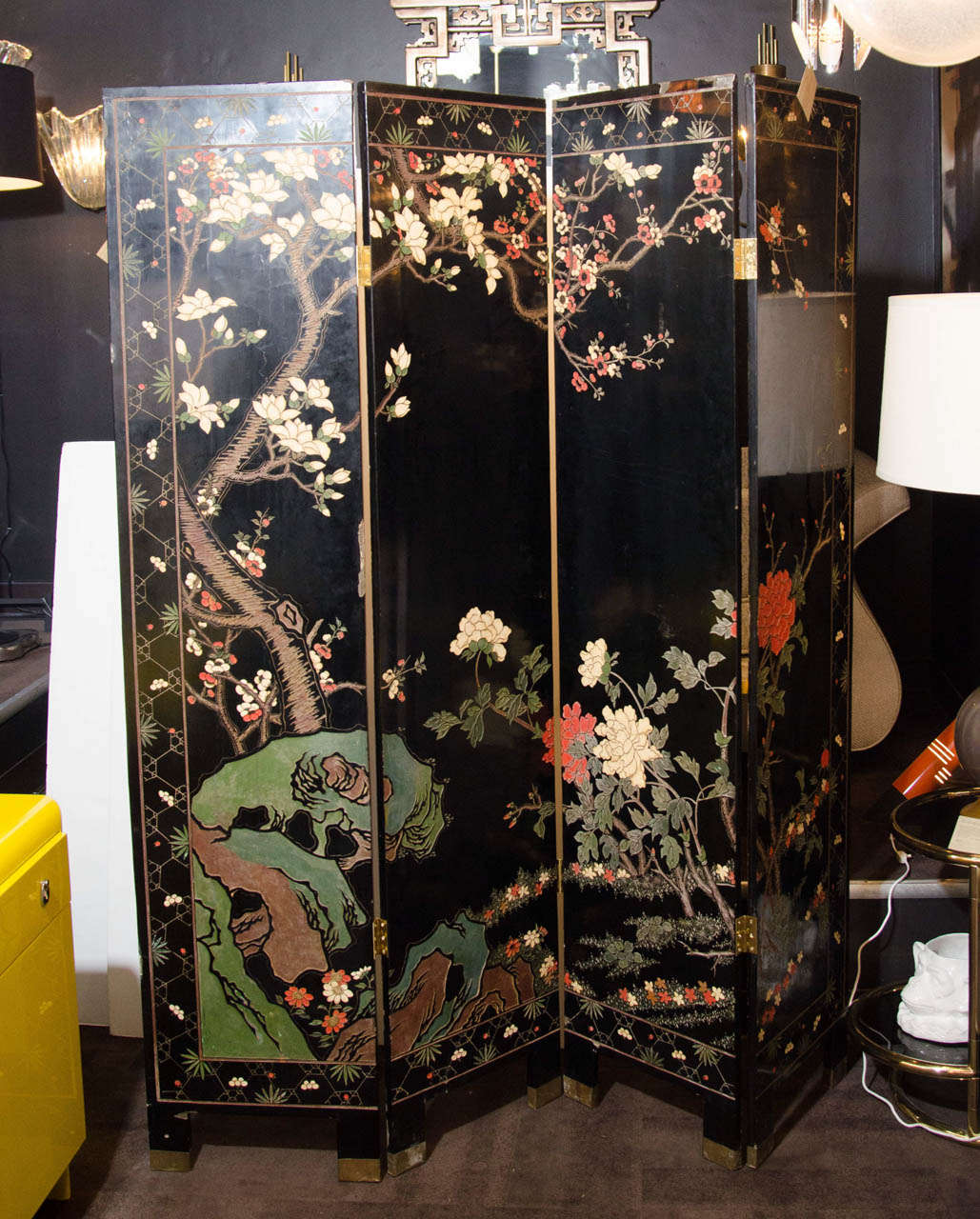 Exquisite four panel screen with hand carved designs and Japanese scenery on both sides of the screens. Hand painted and carved in vibrant hues of gold leaf, red, green, blue, and yellow over black lacquered background. Four panels - each panel is