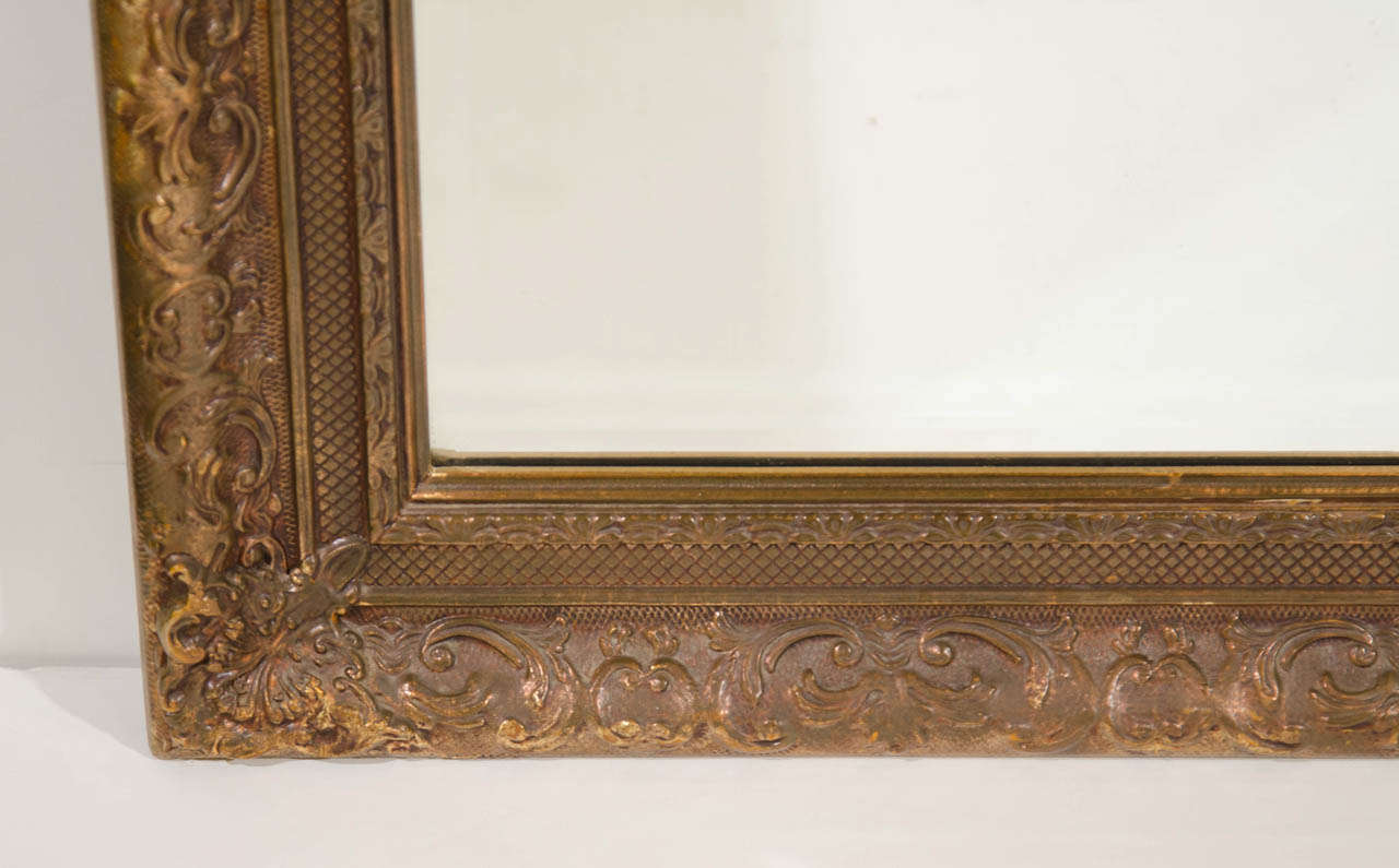 Elegant Large Italian Antiqued Gilt Wood Mirror With Hand Carved Elegant Large Italian Antiqued Gilt Wood Mirror With Hand Carved Frame In Excellent Condition For