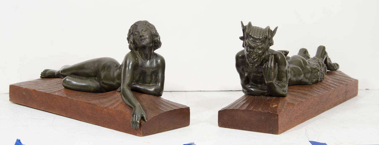 A pair of bronze Art Deco statues of "Pan and Lover" on wooden bases.  Unsigned.