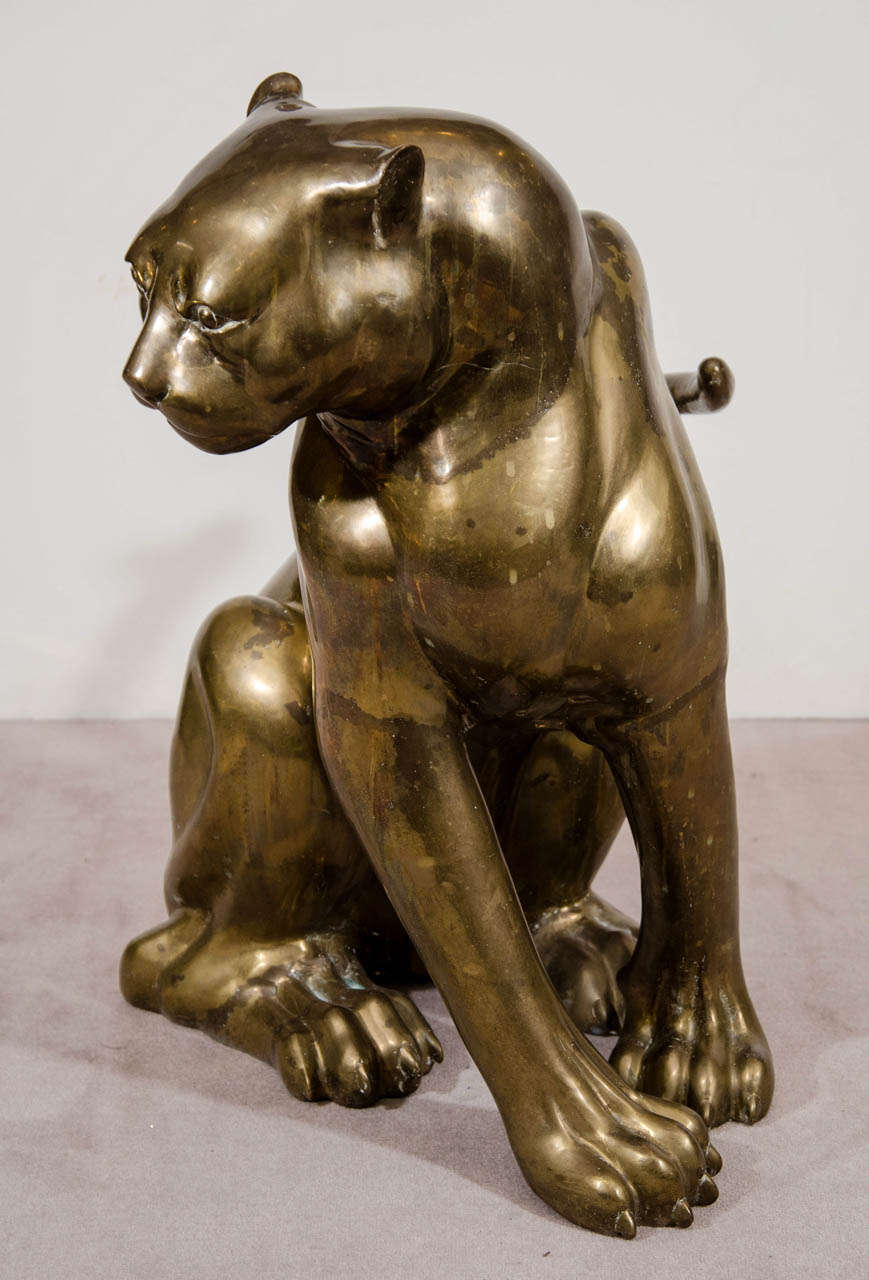 A vintage large brass sculpture of a sitting panther possibly looking at its prey.

Sculpture is in good vintage condition with some wear and stains to brass as well as small scratches and nicks to the surface.
