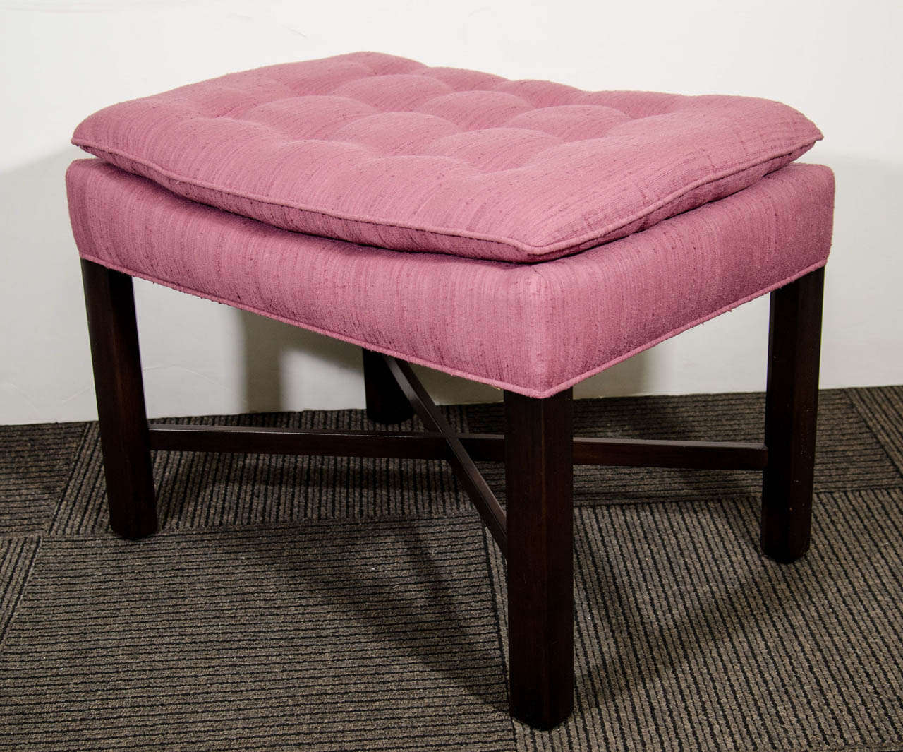 A vintage pair of wooden x-form benches upholstered in button tufted rose fabric.
