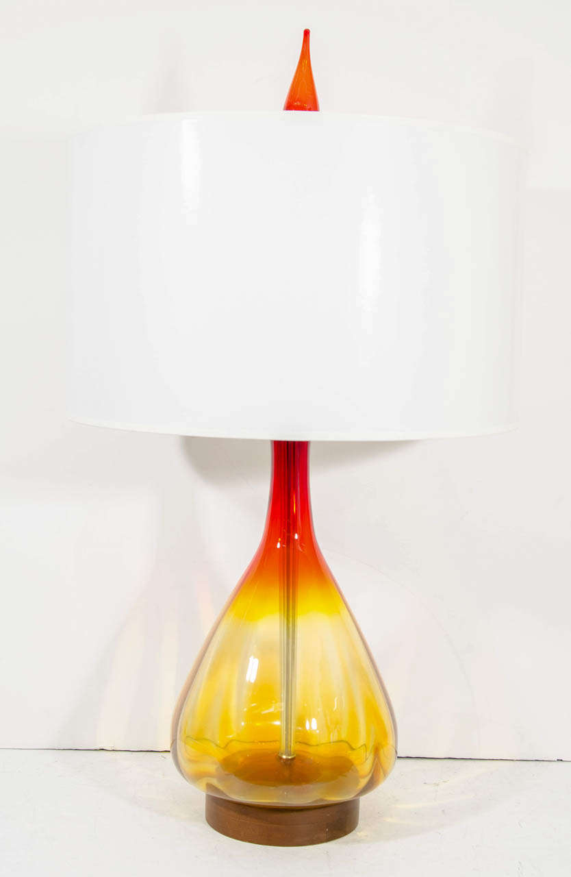A vintage large amber and orange glass Blenko vase converted into a table lamp with glass finial