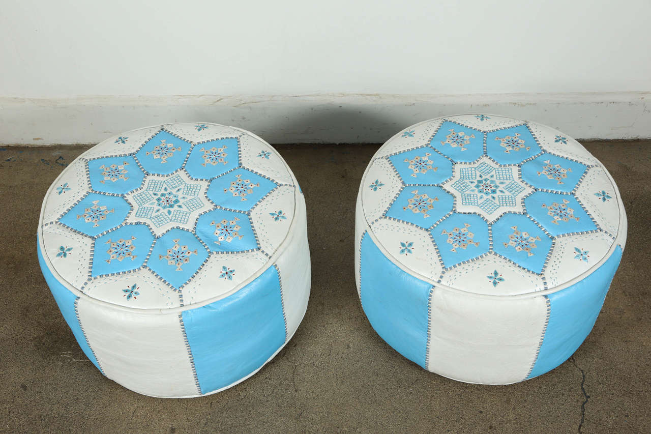 Handcrafted pair of hand-stitched leather Moroccan poufs, in turquoise blue and white, hand embroidered with star designs.
High quality white and Tiffany blue round leather ottomans filled with hard foam, great for a kids room to sit on as a stool,