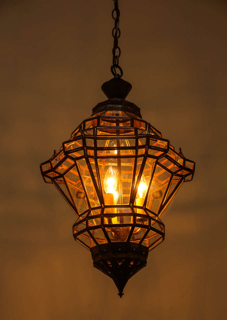 Smaller version of our elegant Granada Moroccan pendant, diamond shape clear glass Moroccan lantern with bronze metal finish.
This vintage handcrafted lantern has a small window to access the inside to change bulbs.
Eleven different levels with