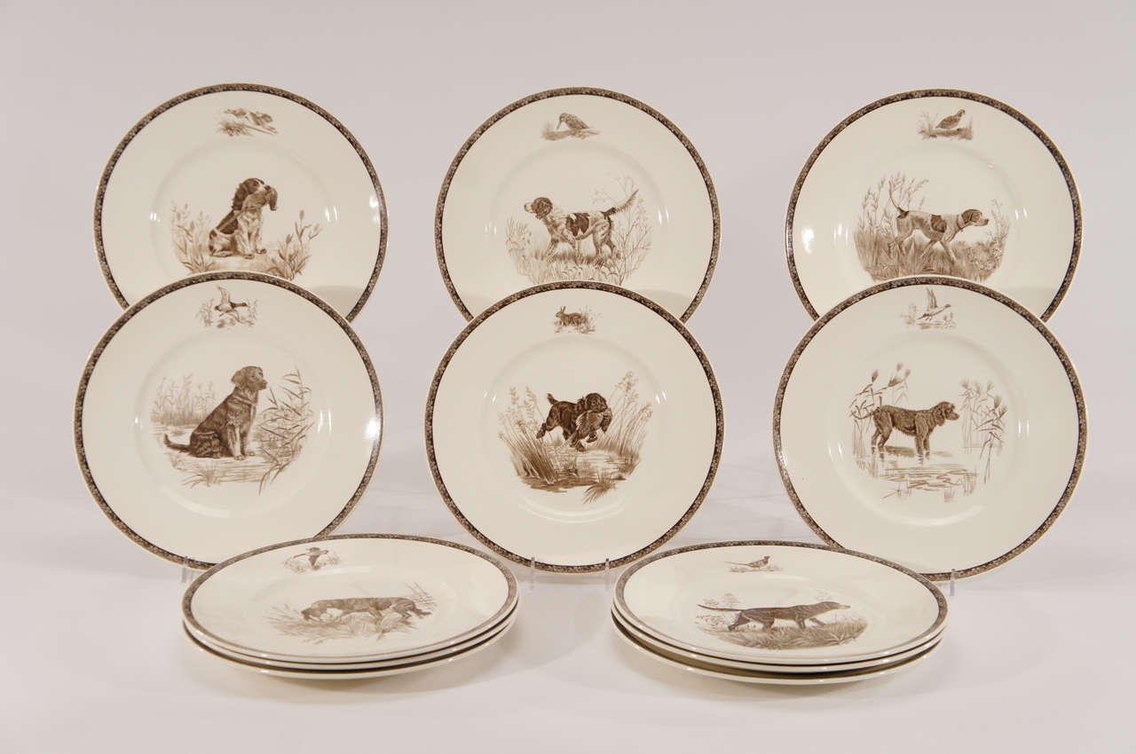 A rare set of 12 Wedgwood dinner plates each decorated in brown enamels depicting a dog lover's dream. The Sporting Dogs of America are represented with the fine and detailed etchings of Marguerite Kirmse (American, 1885-1954), a renown breeder and