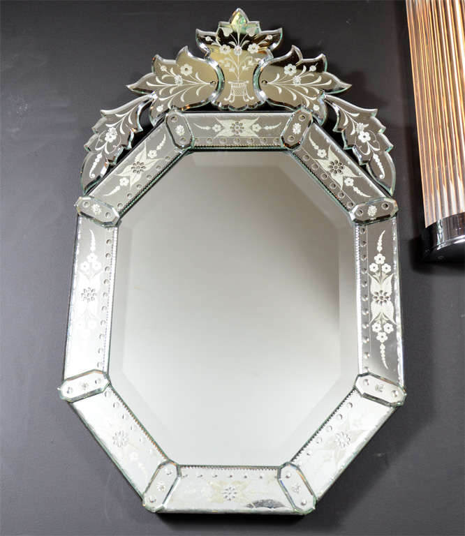 Fabulous reverse etched and beveled, octagonal Venetian mirror. Reverse etched convex and floral detailing on the border and an upper cartouche. This is a beautiful mirror that would look great on any wall or it is the perfect size for a powder room.