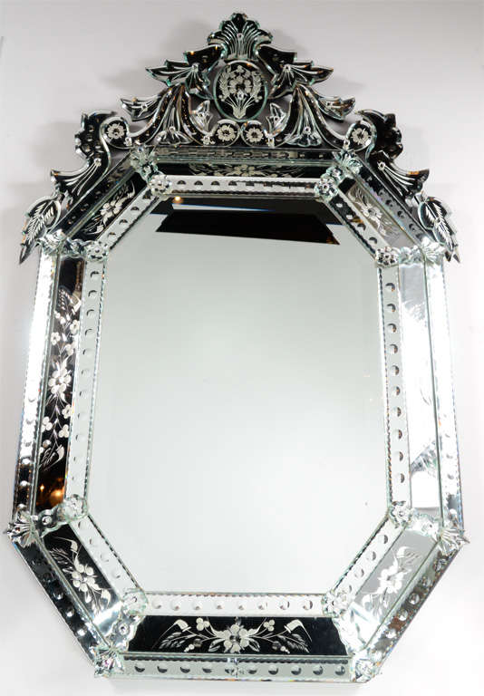 Outstanding, reverse etched and beveled, octagonal Venetian mirror. Reverse etched convex and floral detailing on the border and an extravagant upper cartouche. This spectacular piece will command attention wherever it may be.