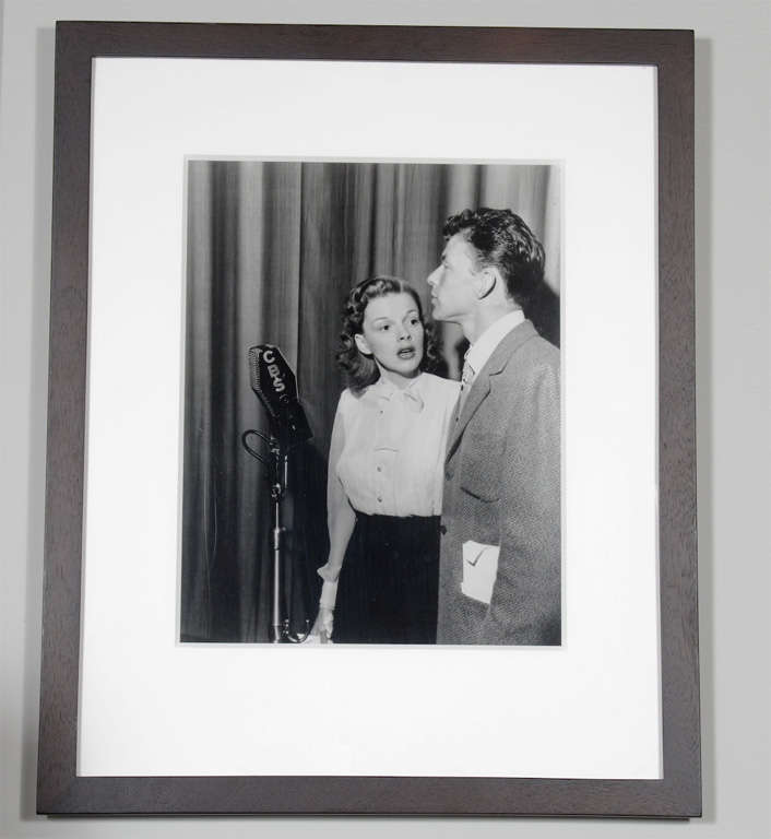 Photograph of Judy Garland and Frank Sinatra framed in museum quality ebonized walnut frame with archival matting. 