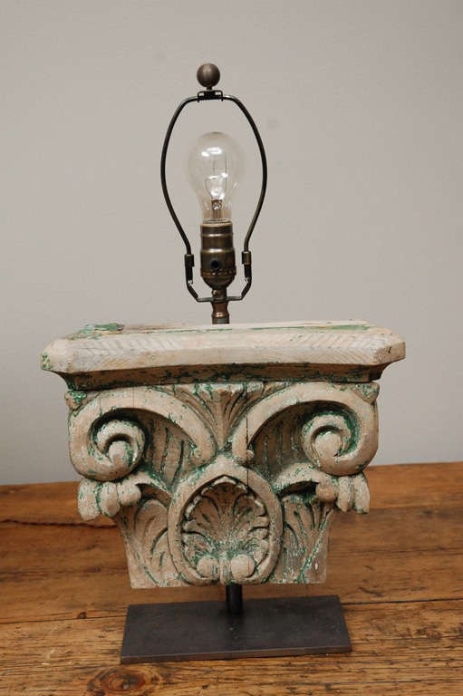 Leaf and scrolled carved wood capitols in remaining paint as table lamps with custom linen shades.