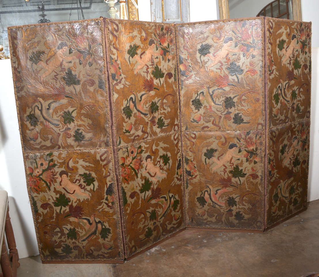 This is a set of 4 folding leather panels made from the wall coverings of a chateau in Pernes les Fontaines, France.  The leather originally covered the walls of the grand salon.  Today the chateau is a national historical landmark housing the City