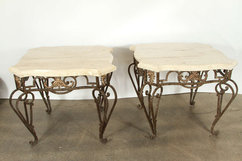Elegant Hand Forged iron pair of garden or patio side tables with travertine top. Beautifully hand forged scrolled gilt wrought iron table, the base are hand made in the Louis XV Style with scrolls and acanthus leaf motifs.

We specialize in rare
