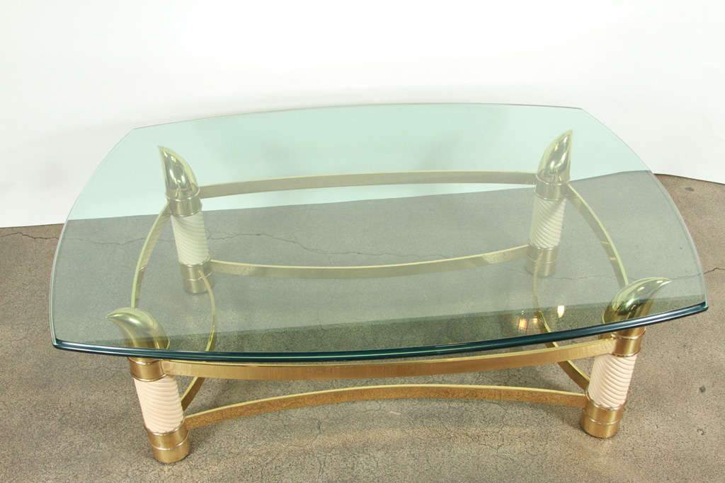 Elegant solid brass coffee table with beveled glass top very nicely designed with faux elephant ivory and brass tusk.
Designed and handcrafted in Italy, Tomasso Barbi style.

We specialize in rare 18th and 19th century Moorish style Antiques,