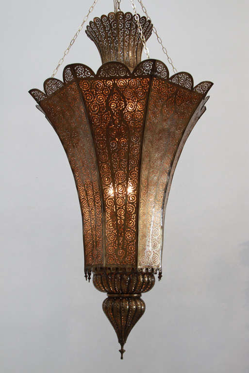 Massive hand-crafted Moroccan Moorish Alhambra Riad openwork pierced metal brass chandelier.
Oversized spectacular, exquisite pierced brass Moroccan chandelier.
Handcrafted and chiseled with fine filigree designs, bronze patina color. Hand-cut and