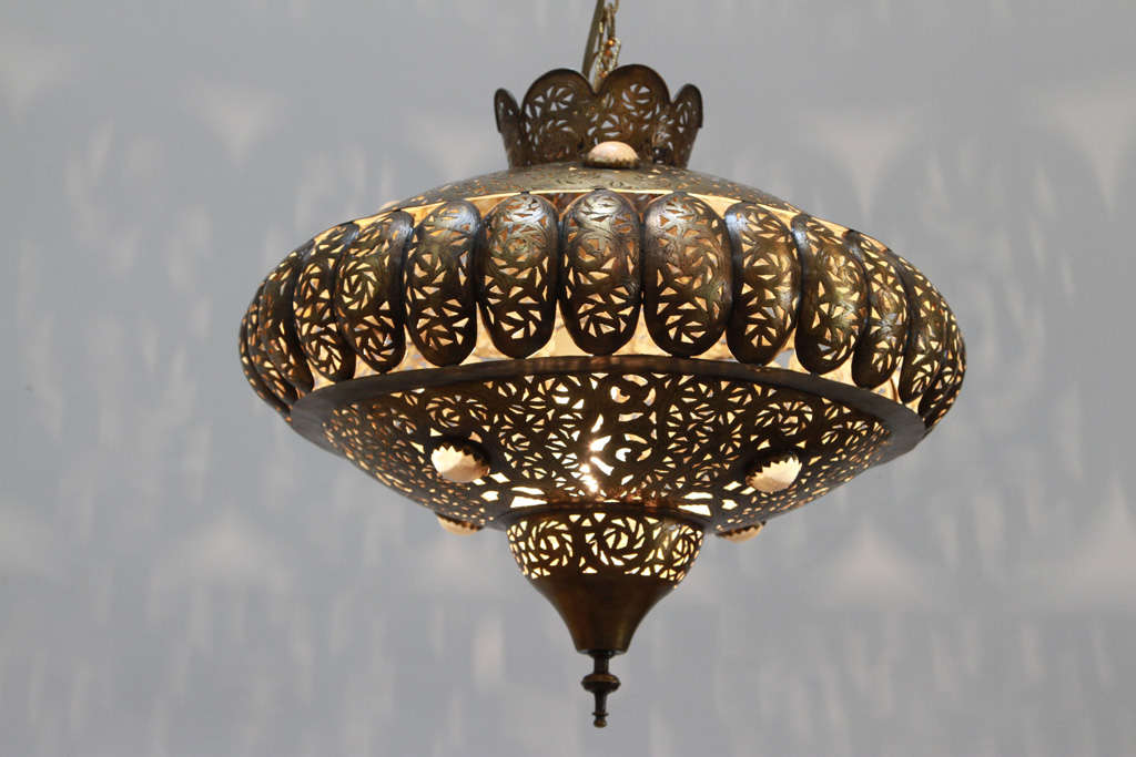 Pierced brass Moroccan pendants in the style of Alberto Pinto Moorish design.
This Moroccan light fixtures are delicately handcrafted and chiseled with fine filigree designs by skilled Moroccan artisans.
The size of the light fixture is 17" H
