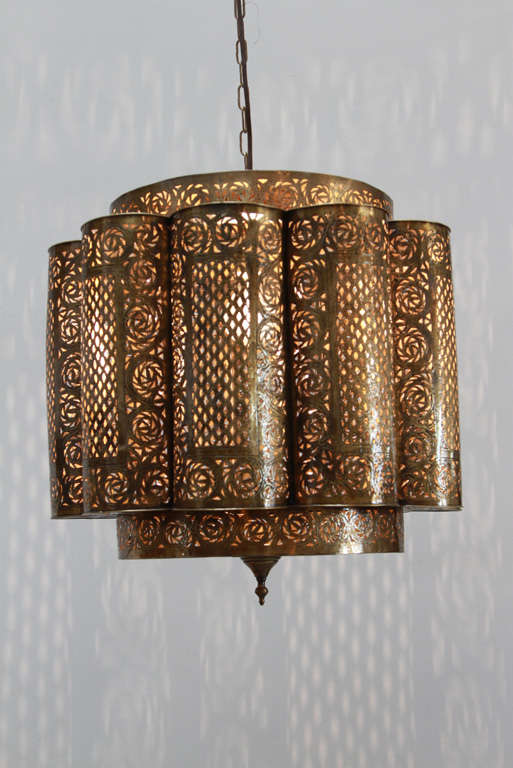 Large Pierced brass Moroccan chandeliers in the style of Alberto Pinto Moorish design.

This Moroccan light fixtures are delicately hand crafted, hand hammered and chiseled with fine filigree designs by skilled Moroccan artisans.
A pair is