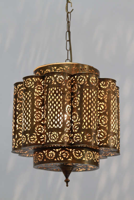 Pierced brass Moroccan chandeliers in the style of Alberto Pinto Moorish design.

This Moroccan light fixtures are delicately hand crafted and chiseled with fine filigree designs by skilled Moroccan artisans.

The size of the light fixture is