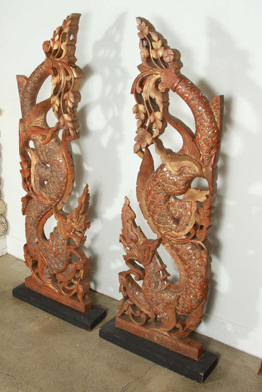 Pair of gilt wood sculpture of dragons, handcrafted in Thailand.
Amazing handwork, gilt wood adorned with small pieces of mirrors, delicate carving. Hand made of teak wood, gold leafed and rhinestones
Architectural wooden sacred architectural