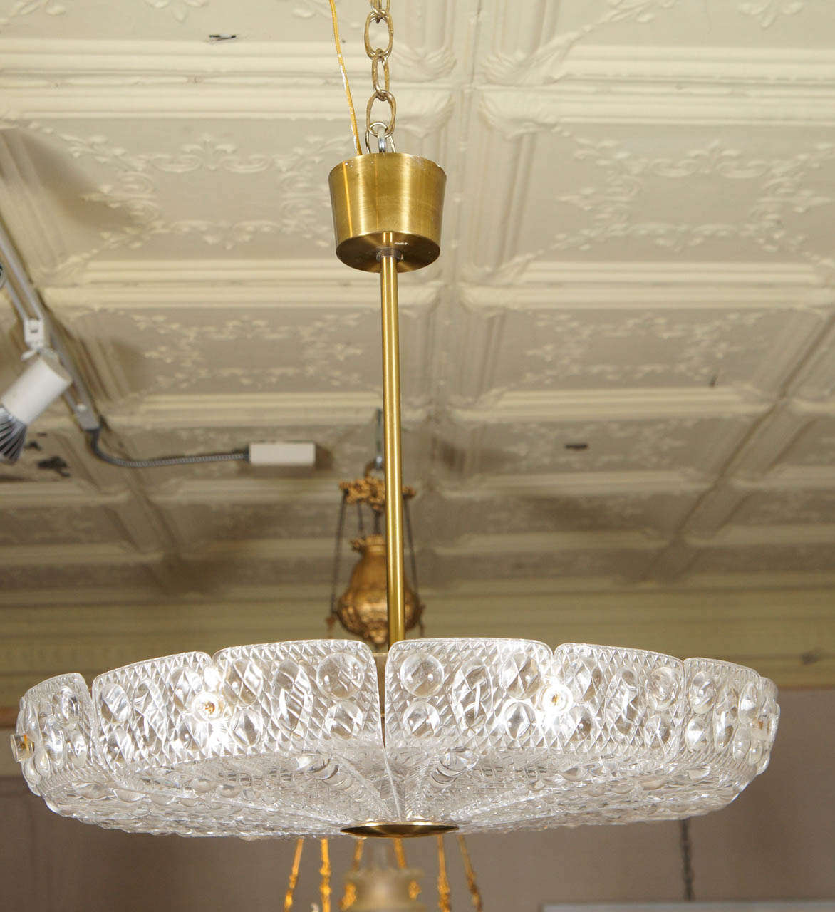 The brass canopy and stem with a large pressed glass shade. 1950s by Carl Fagerlund for Orrefors.