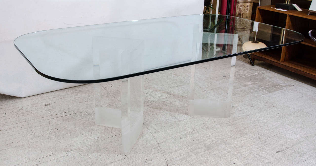 Beautiful glass top dining table with lucite base. The base is two substantial pieces of chevron shaped thick lucite with a frosted band at the tops. Please contact for location.