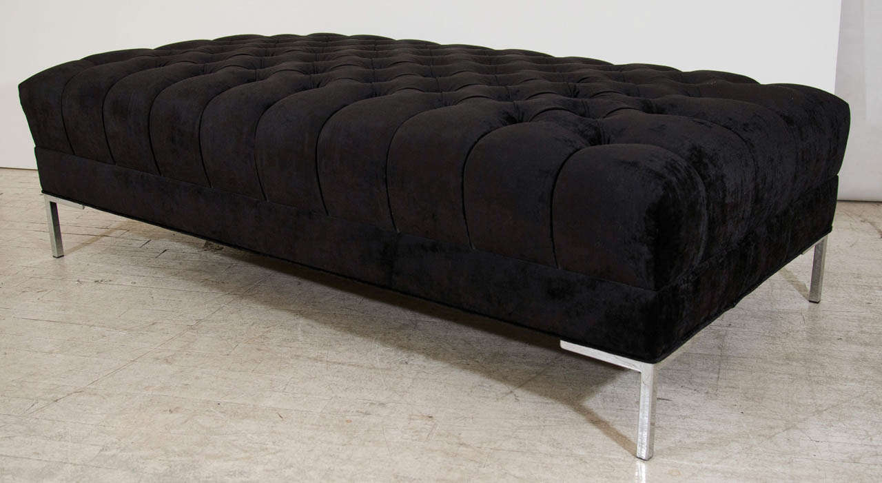 Beautiful bench upholstered in a deeply tufted velvet; shown here in a Classic Black. It is both beautiful and versatile; broad enough to support serving trays, some designers have used it as a coffee table. This piece is designed by and is part of