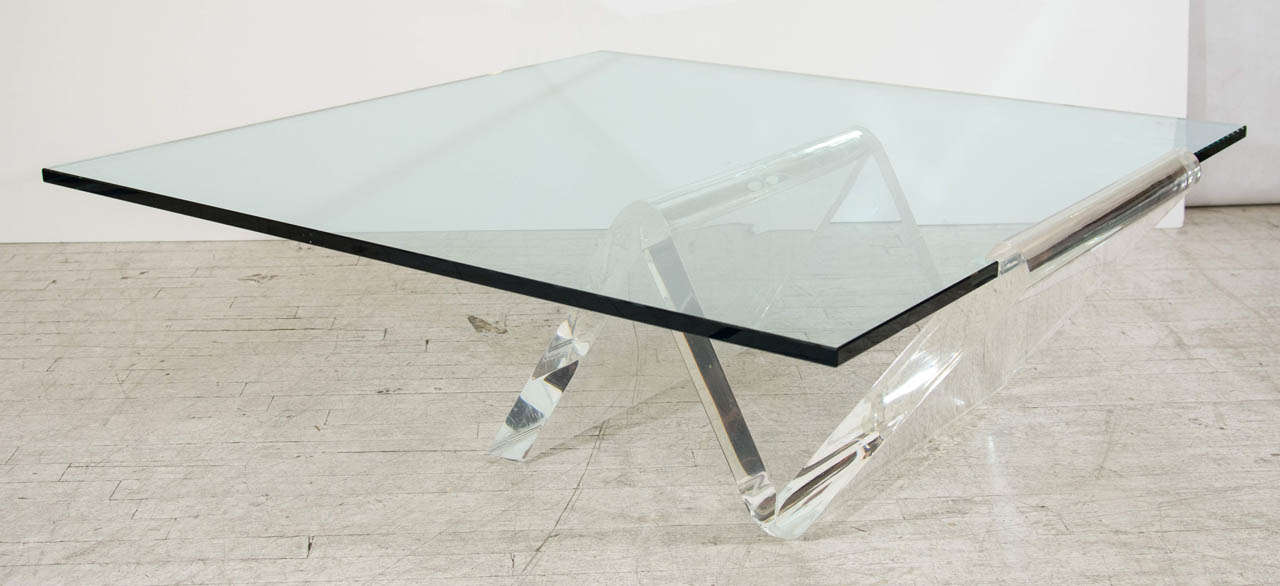 This large coffee table has a broad glass top dramatically cantilevered from a beautifully sculptural, thick lucite base. Impressive! Please contact for location.